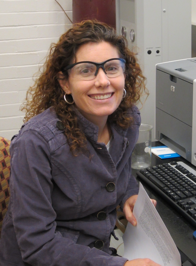 Photo of Melissa Schultz with safety glasses in an instrument room