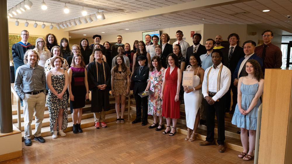 2023 PBK Inductees with Faculty and Staff smiling at the camera in Scheide Music Center