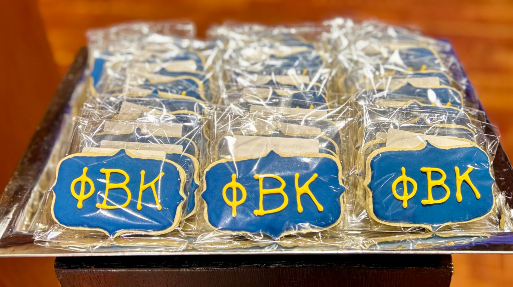 a tray of individually wrapped sugar cookies decorated with PBK