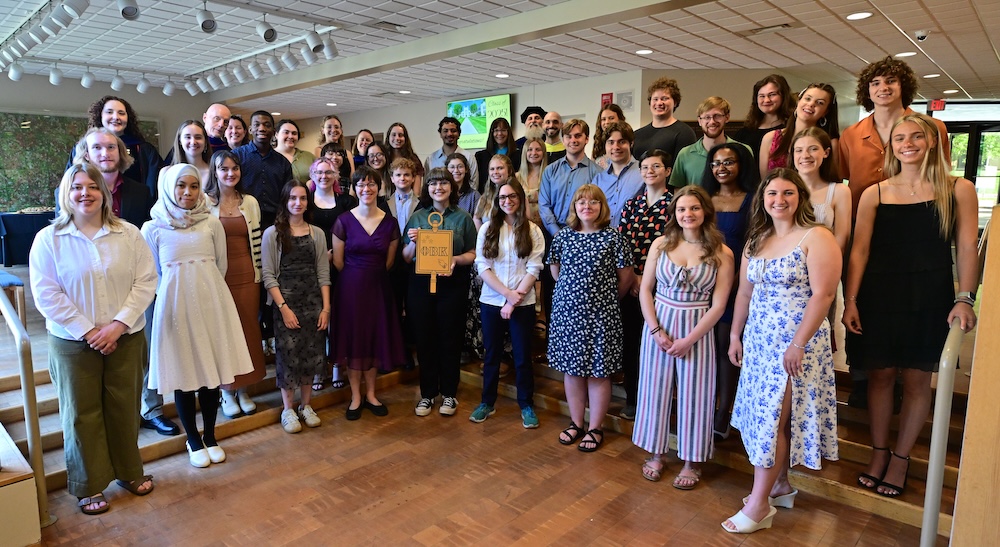 2025 PBK Inductees with Faculty and Staff smiling at the camera in Scheide Music Center