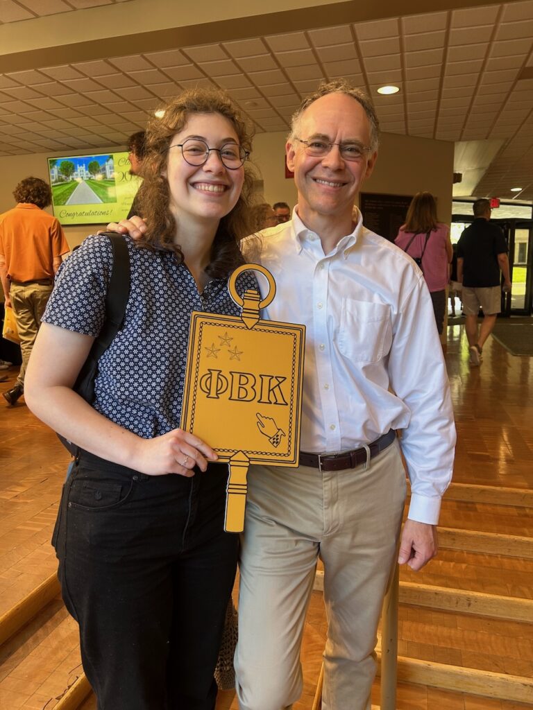a 2025 PBK Inductee and parent smile at the camera in Scheide Music Center