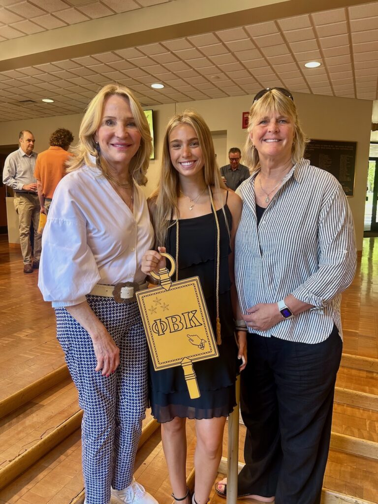 a 2025 PBK Inductee and family smile at the camera in Scheide Music Center