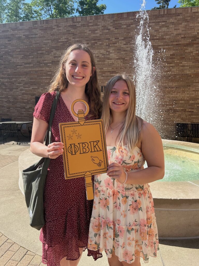 two 2025 Inductees holding the PBK key smile at the camera in Scheide Music Center