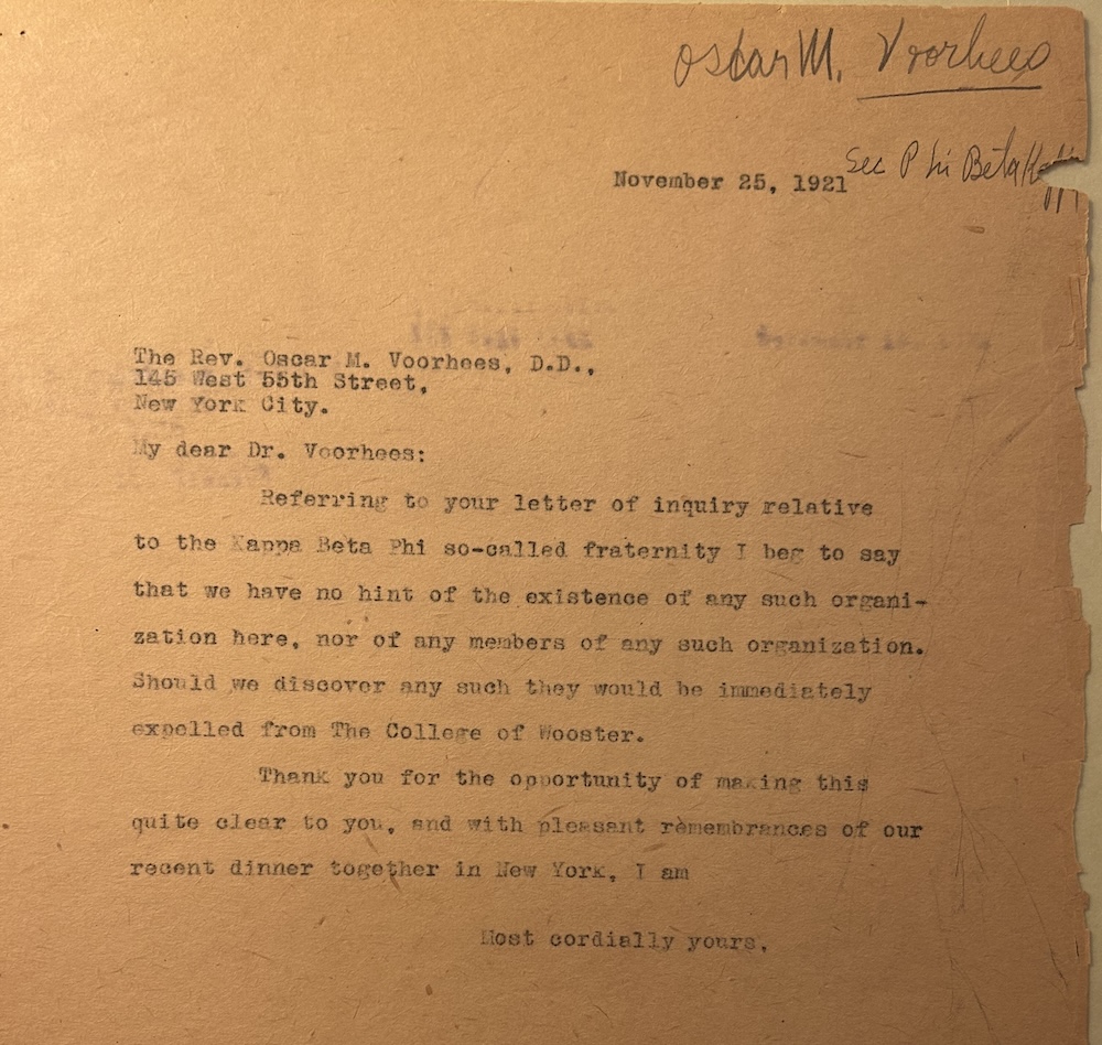 Scanned typed letter dated November 25, 1921, addressed to the Rev. Oscar M. Voorhees, D.D., New York City. The sender (on College of Wooster letterhead) states that no “Kappa Beta Phi” fraternity exists at Wooster and warns that any members discovered would be immediately expelled.