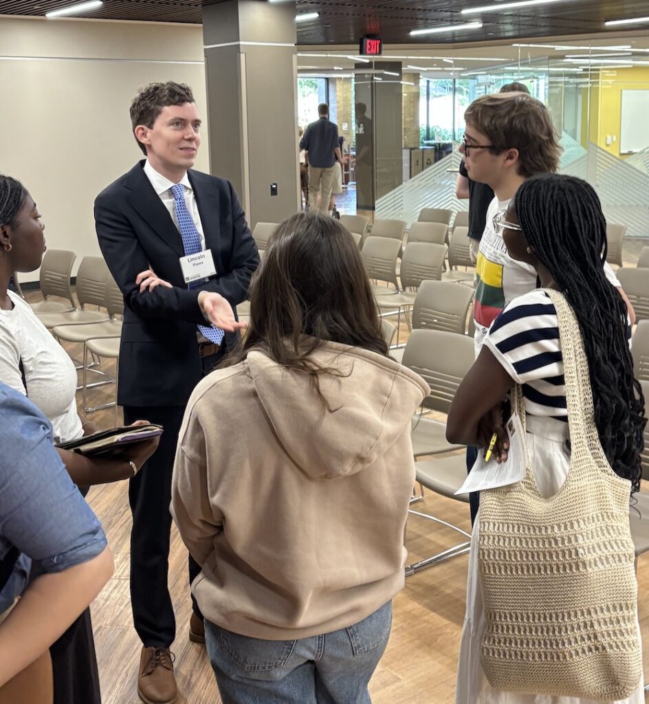 Lincoln Plews '15 speaks with students in the Alley