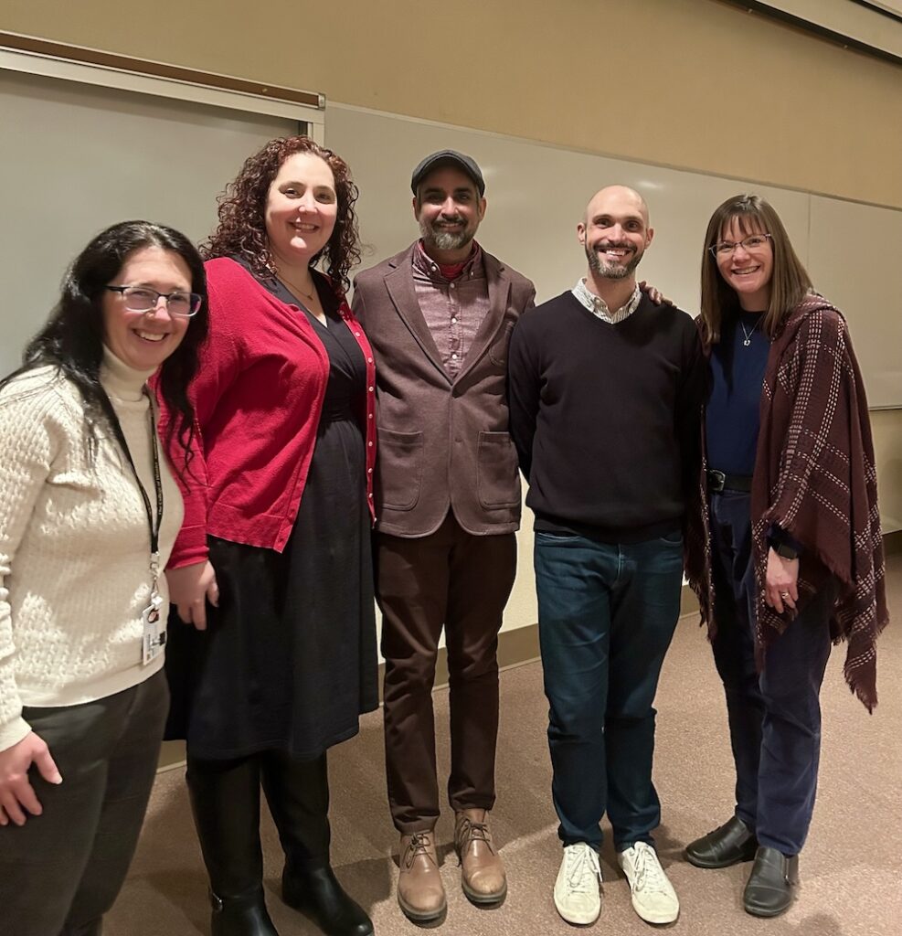 4 Wooster PBK members with visiting scholar smiling at camera in Lean Lecture Hall