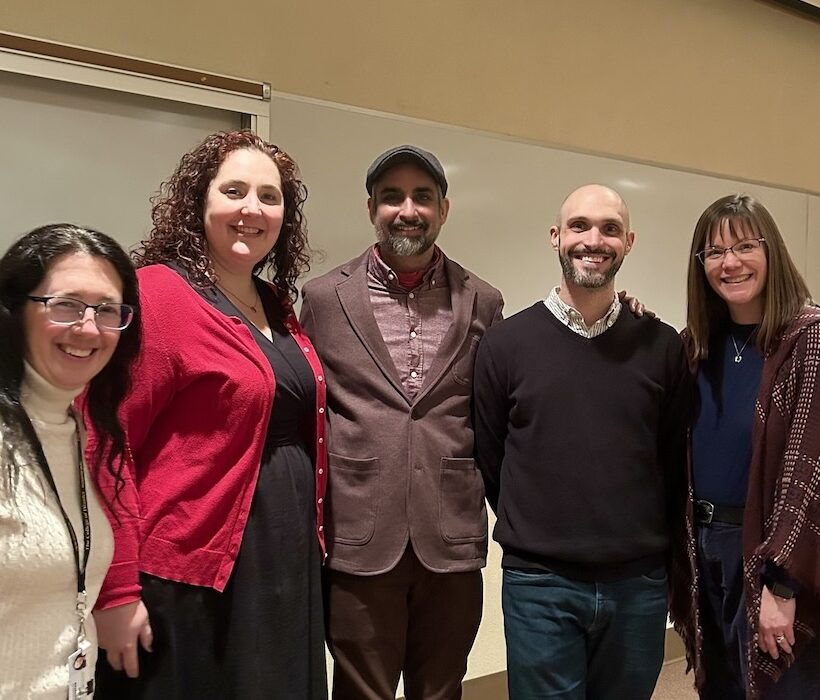 4 Wooster PBK members with visiting scholar smiling at camera in Lean Lecture Hall