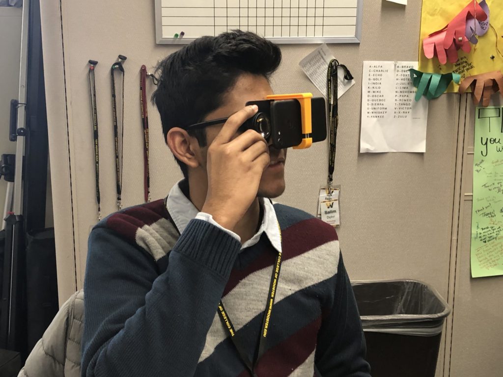 image of student viewing VR content through cardboard
