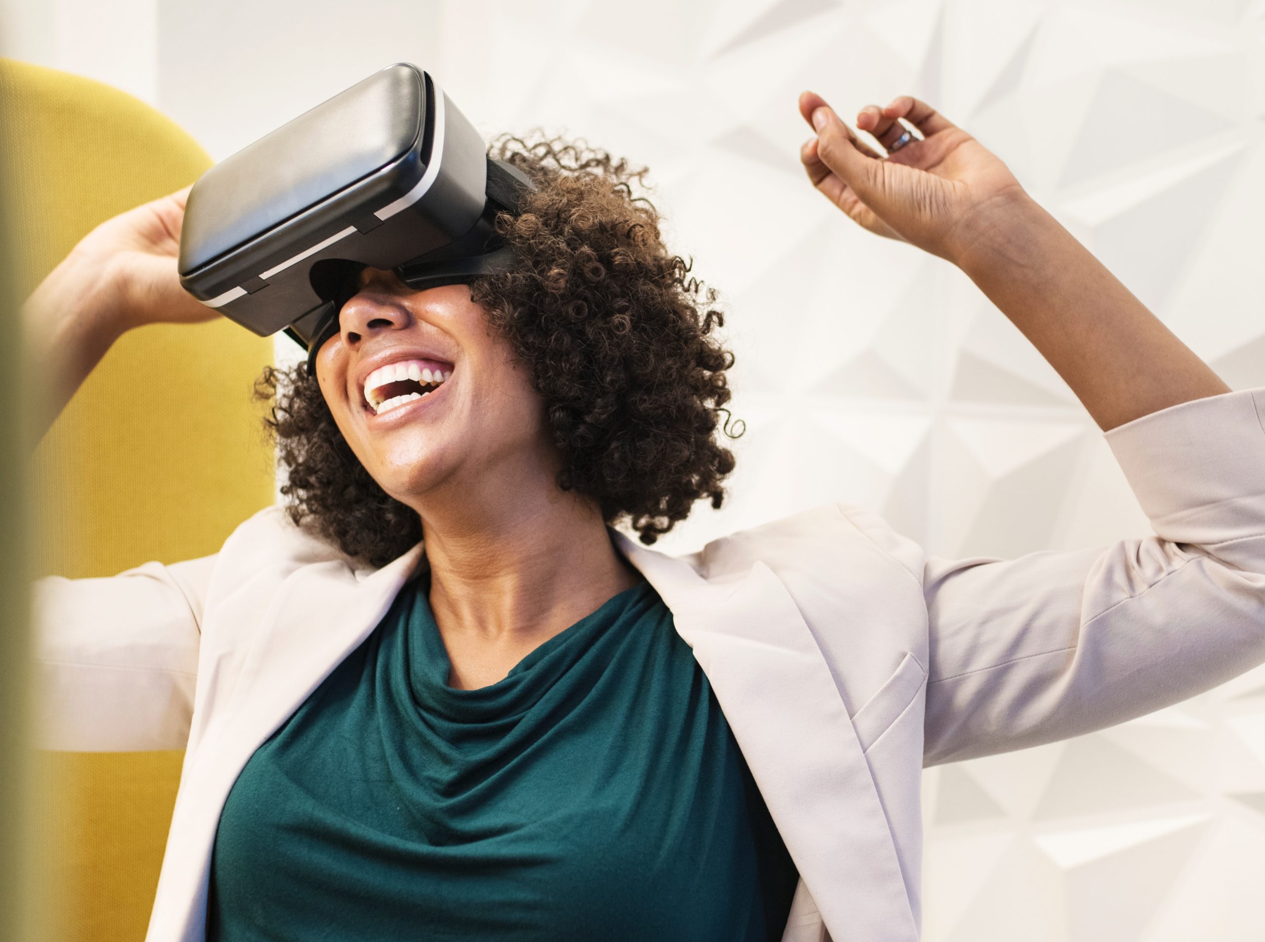 A woman smiling while wearing virtual reality headset