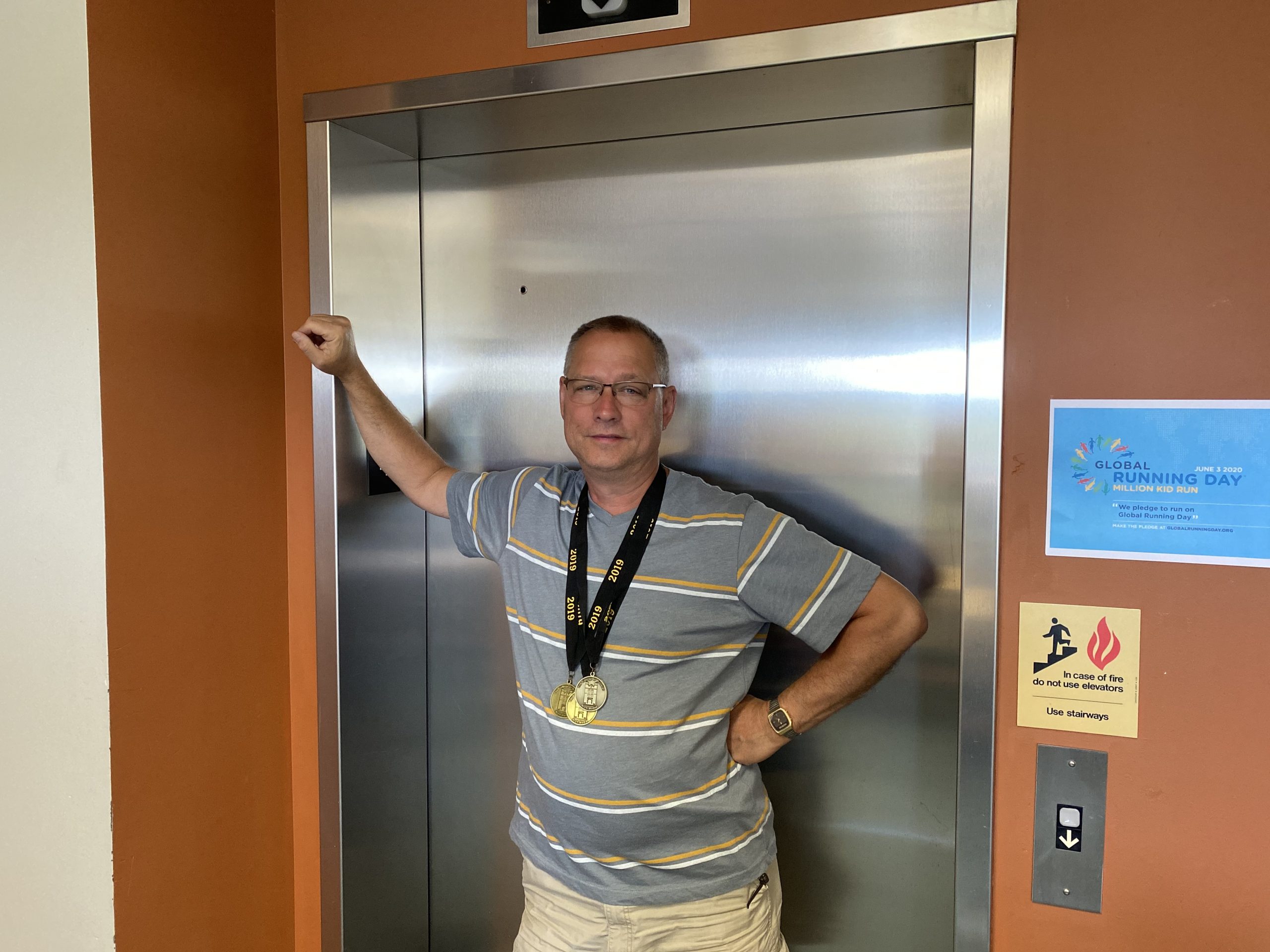 Image of Dan Krites in front of elevator doors