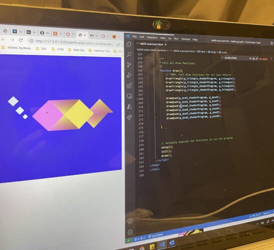 photograph of a computer monitor with code and a colorful graphic